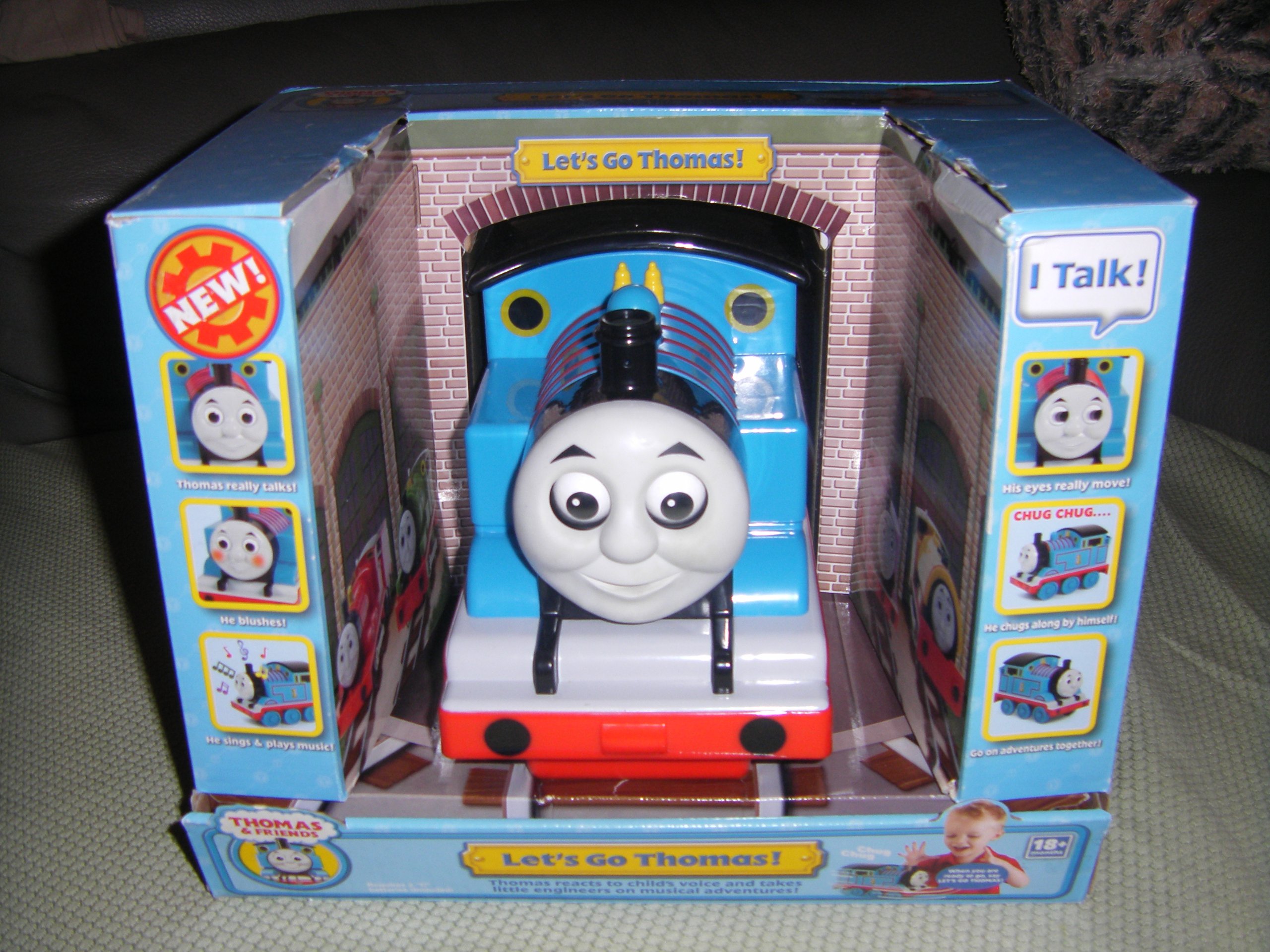 A Let's Go Thomas toy in box. This photo shows the front of it.